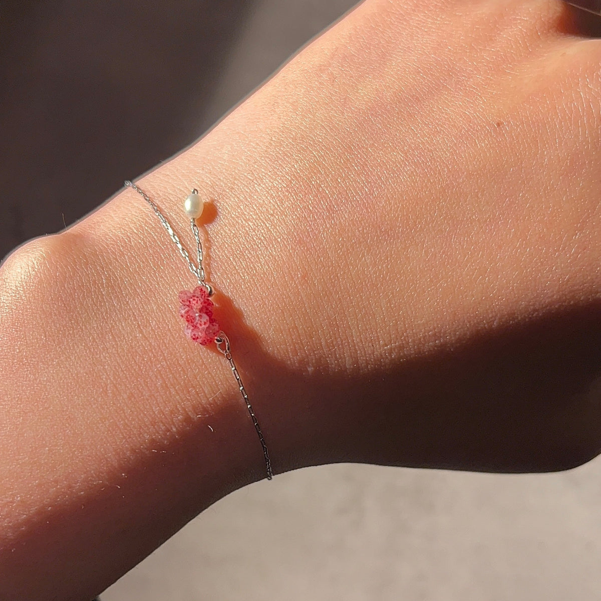 Rose Blossom Bracelet worn on a wrist in sunlight